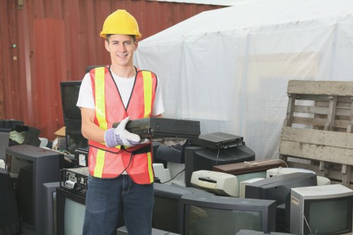 Recycling bins and separated materials ready for transfer at a clearance site