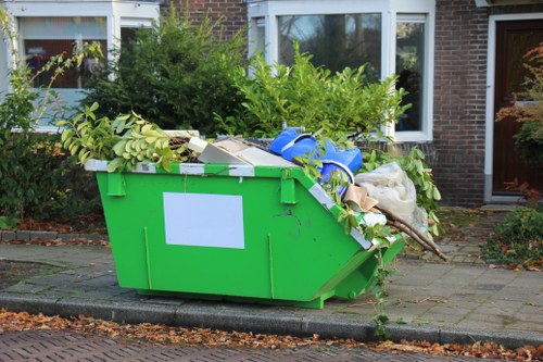 Workers loading cleared items into a lorry following safety procedures